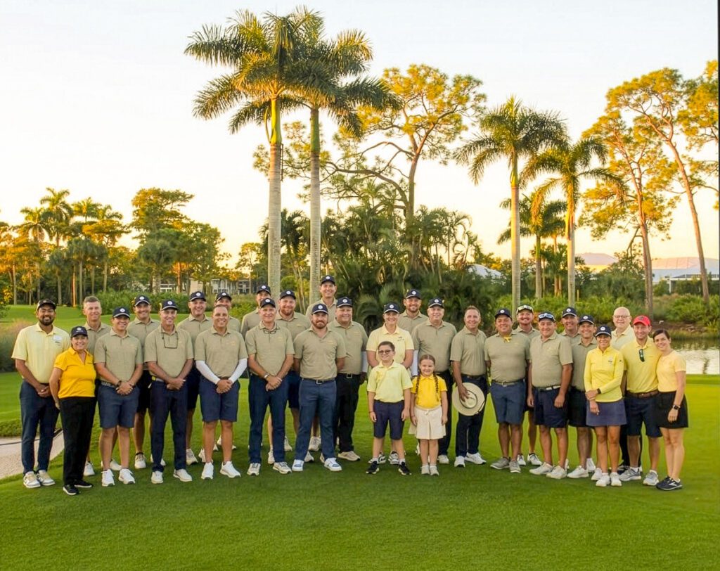 Group of Play Yellow golf event participants posing together on a golf course.